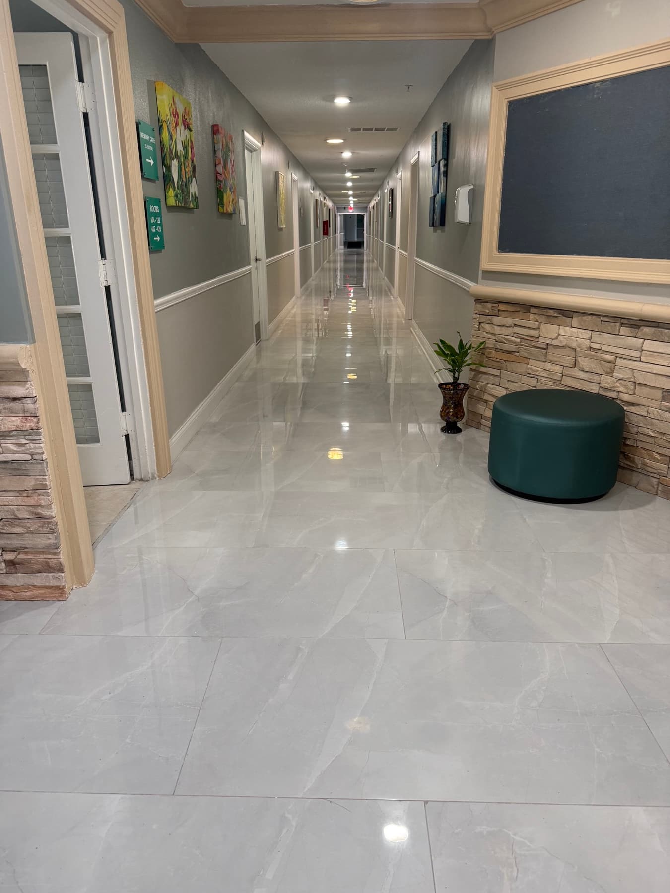 Bright resident hallway with polished floors and artwork