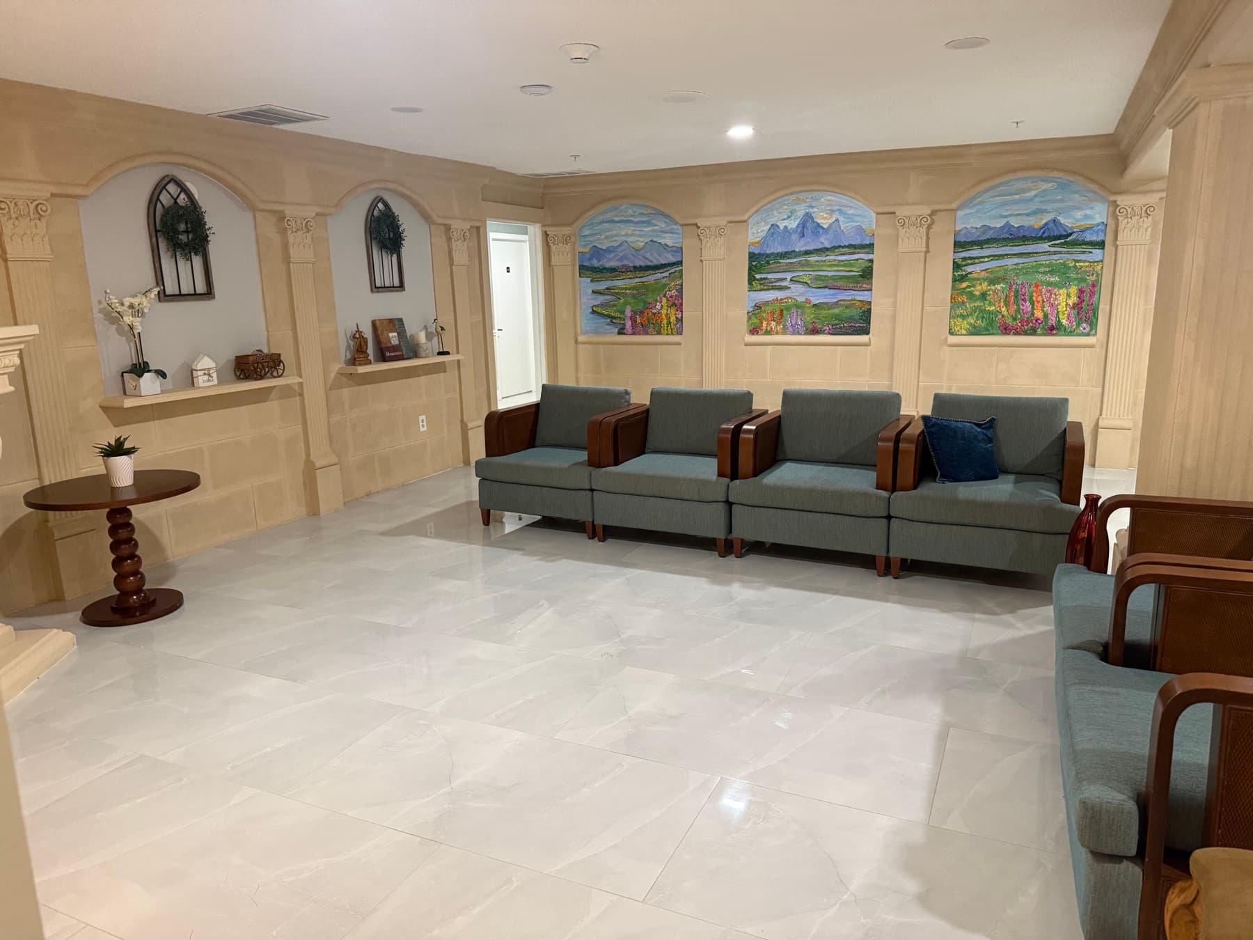 Resident sitting room with mountain murals, arched alcoves and comfortable seating